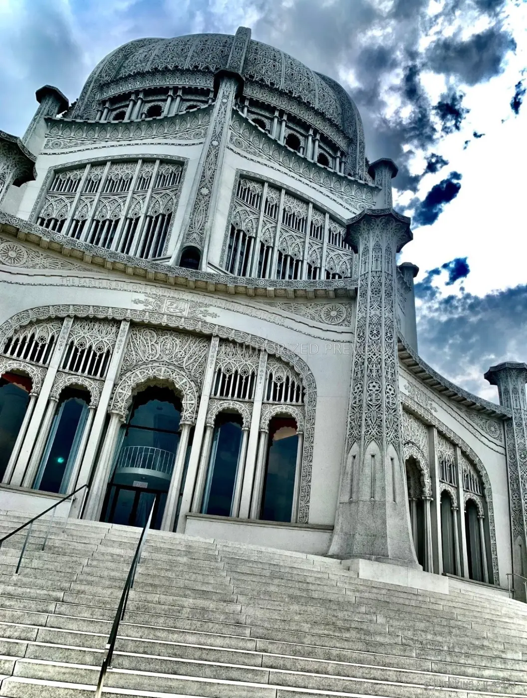 Ornate white domed building beneath dramatic clouds