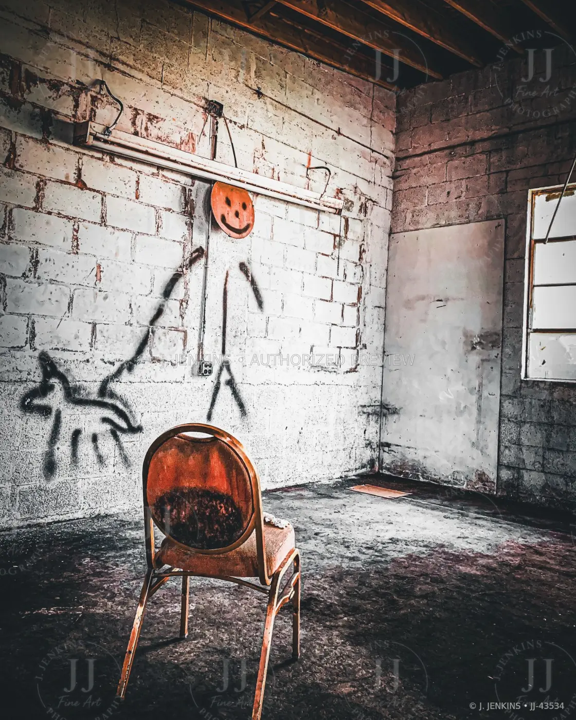 A single worn chair inside an abandoned industrial room